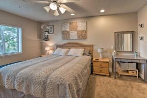 a bedroom with a bed and a desk and a ceiling fan at Cozy-Chic Condo with Pool Access 1 Block to Beach! in Lake Havasu City