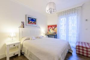 Łóżko lub łóżka w pokoju w obiekcie Colon Zurriola IB Apartments