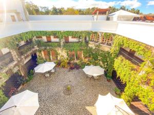 an overhead view of a patio with white umbrellas at El Carmen Suites in Antigua Guatemala