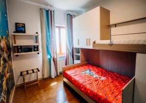 a bedroom with a bunk bed with a red comforter at L'Isola che non c'è in Senigallia