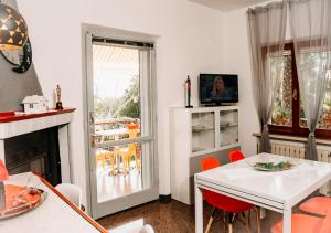 a living room with a white table and a fireplace at L'Isola che non c'è in Senigallia