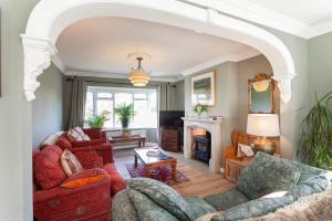 a living room with two couches and a fireplace at Quorn Farmhouse in Quorndon