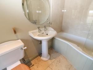 a bathroom with a sink and a toilet and a tub at Low Shipley Cottage in Cotherstone +22 photos