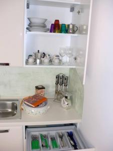 a refrigerator filled with lots of dishes and utensils at Le Terrazze in Otranto