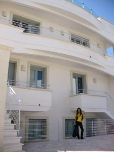 a woman standing in front of a building at Le Terrazze in Otranto