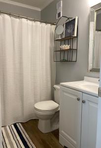 a white bathroom with a toilet and a sink at Steps away from the BEACH!!! in Hilton Head Island