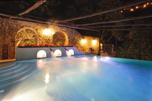a swimming pool at night with lights at Villa Alba d'Oro in Amalfi