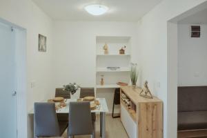 a kitchen and dining room with a table and chairs at Apartments Pr' Štormanu in Kanal