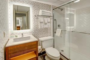 a bathroom with a toilet and a sink and a shower at Holiday Inn East Windsor, an IHG Hotel in Hightstown