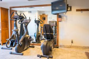 a gym with treadmills and elliptical machines at La Tour des Voyageurs II in Mont-Tremblant