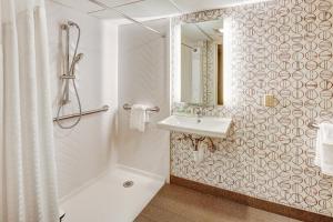 a white bathroom with a sink and a mirror at Holiday Inn East Windsor, an IHG Hotel in Hightstown