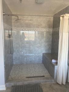 a bathroom with a shower with a shower curtain at River Place Condos #711 3BD in Pigeon Forge