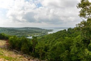a view of a river from a hill with trees at Lodge 73 in Branson
