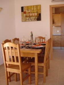 a dining room table with chairs and wine glasses at Apartamentos Atlantico by OA in Albufeira