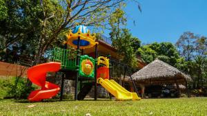 a playground with a slide in the grass at Hotel Poza Blanca Lodge in San Mateo