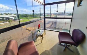 an office with a view of an airport from a window at Hotel Vale da Serra in Parauapebas