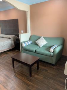 a living room with a couch and a coffee table at Sterling Inn and Suites at Reliant and Medical Center Houston in Houston