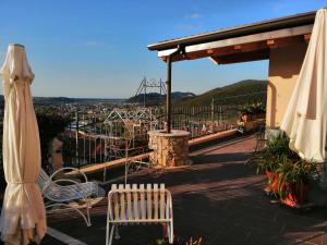 a balcony with two chairs and a view of a city at Ca' Pietra di Nonno Pietro in Gavardo