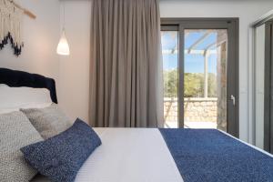 Posteľ alebo postele v izbe v ubytovaní Askelinos Villas + 14 fotografií