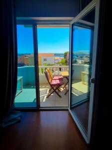 a view of a balcony with a table and a chair at Apartments Štokić in Rab
