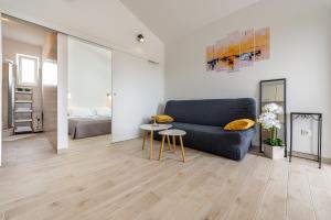 a living room with a couch and a table at Apartmani Opg Dragoslavić in Stari Vas