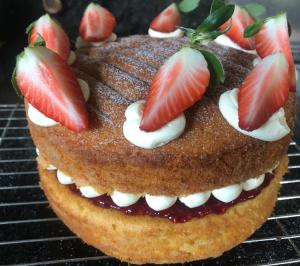 a chocolate cake with strawberries on a cooling rack at Hall Farm Bed & Breakfast in Terrington