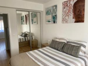 Schlafzimmer mit einem Bett und einem Spiegel in der Unterkunft Appartement à Esmoriz de 3 pièces - 72m2 in Esmoriz