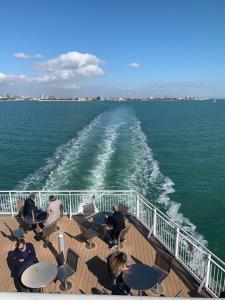 a group of people sitting on the deck of a ferry at WIGHTHOLIDAY in Ryde