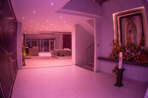 a living room with purple lighting and a candle at Harmony Hotel in Ipiales
