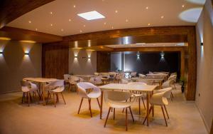 a row of tables and chairs in a restaurant at Harmony Hotel in Ipiales