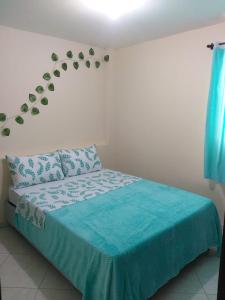 a bedroom with a bed with a blue comforter at Hermoso Apartamento en San Gil in San Gil