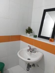 a bathroom with a white sink and a mirror at Hermoso Apartamento en San Gil in San Gil