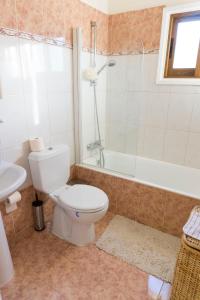 a bathroom with a toilet and a tub and a sink at Chara Elizabeth No 2 Villa in Protaras