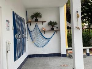a blue hammock hanging on the side of a house at Cabañas Los Juanchos Coveñas in Coveñas