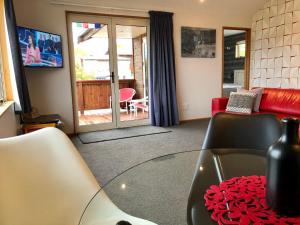 a living room with a couch and a glass table at The Snug in Twizel