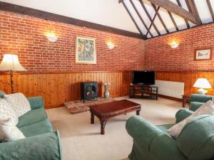 a living room with a couch and a coffee table at Pear Tree in Wood Norton