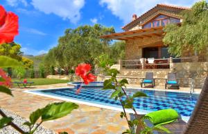 a villa with a pool and a house at Villa Tireda in Keri