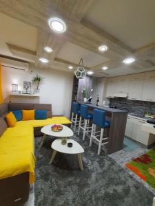 salon z żółtym łóżkiem i kuchnią w obiekcie Harmony apartment - beautiful central location w mieście Herceg Novi