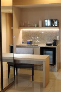 a kitchen with a table and a counter top at Localização incrível vista ótima equipado e novo in Brasilia