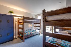 a room with two bunk beds in a room at The Bivvi Hostel Telluride in Telluride