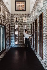 a man standing in a room with brick walls at Serafino McLaren Vale in McLaren Vale