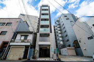 een hoog gebouw voor sommige gebouwen bij STAY IN YEBISU in Osaka