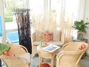 a living room with a couch and chairs and a table at Airport Fashion Hotel in Düsseldorf