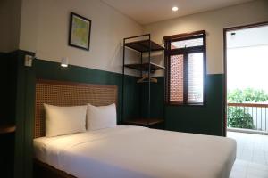 Uma cama ou camas num quarto em Liberta Malioboro South