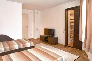 una camera d'albergo con due letti e una televisione di Pepi Guest House a Veliko Tŭrnovo