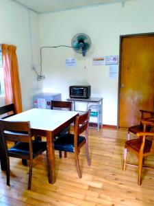 a dining room with a table and chairs at Soboroong Farmer's Cottage in Kundasang
