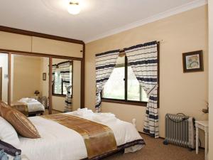 a bedroom with a bed and a large window at Hope in Exeter