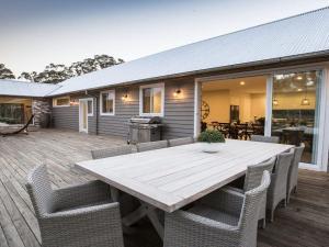 a wooden table and chairs on a deck at Amaroo in Bowral