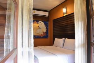 Postel nebo postele na pokoji v ubytování Baanfai Guesthouse Chiangkhong