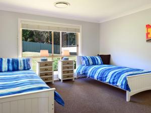 A bed or beds in a room at Sunset over Neptune - pet friendly, 5 min to beach